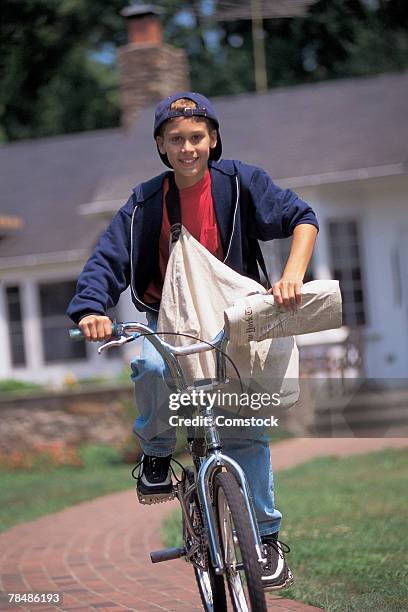 newspaper boy riding bike - zeitungsausträger stock-fotos und bilder