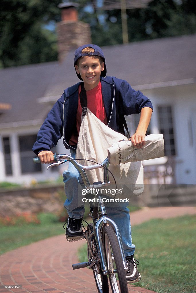 Newspaper boy riding bike