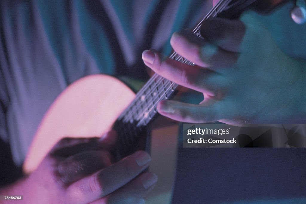 Hands playing mandolin