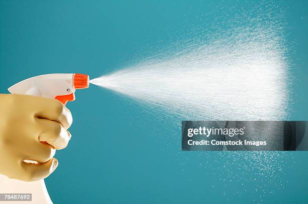 hand in rubber glove spraying cleanser - spray nozzle stock pictures, royalty-free photos & images