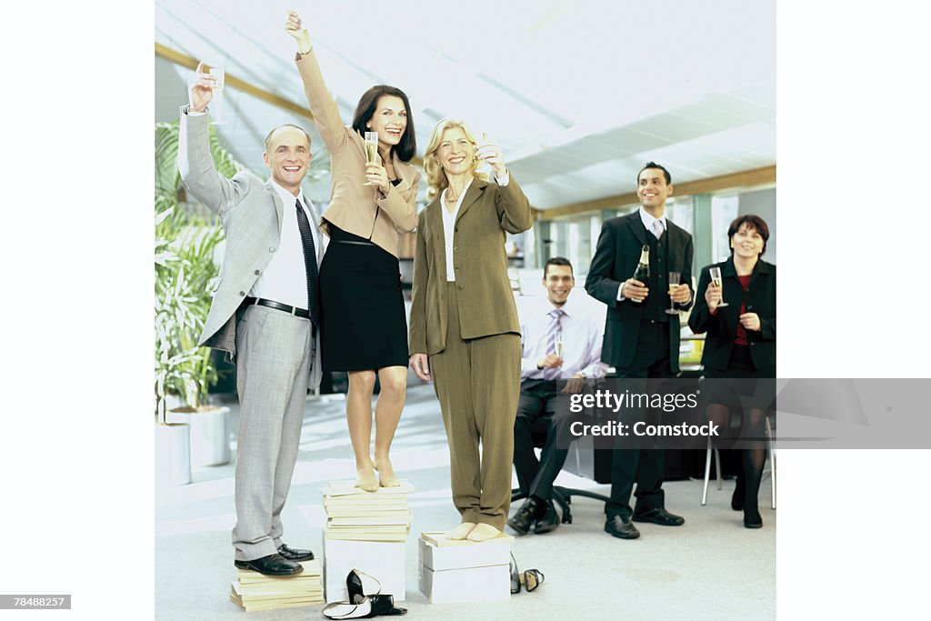 Businesspeople celebrating in office