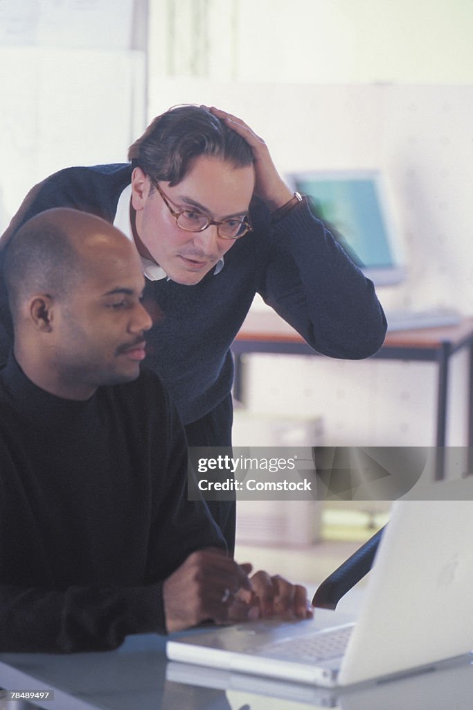 Men working with a computer