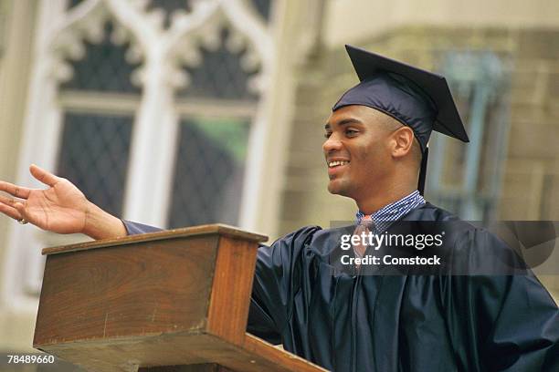 young man giving graduation speech - graduation podium stockfoto's en -beelden