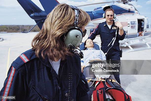 paramedics transporting patient - paramedics helicopter stock pictures, royalty-free photos & images