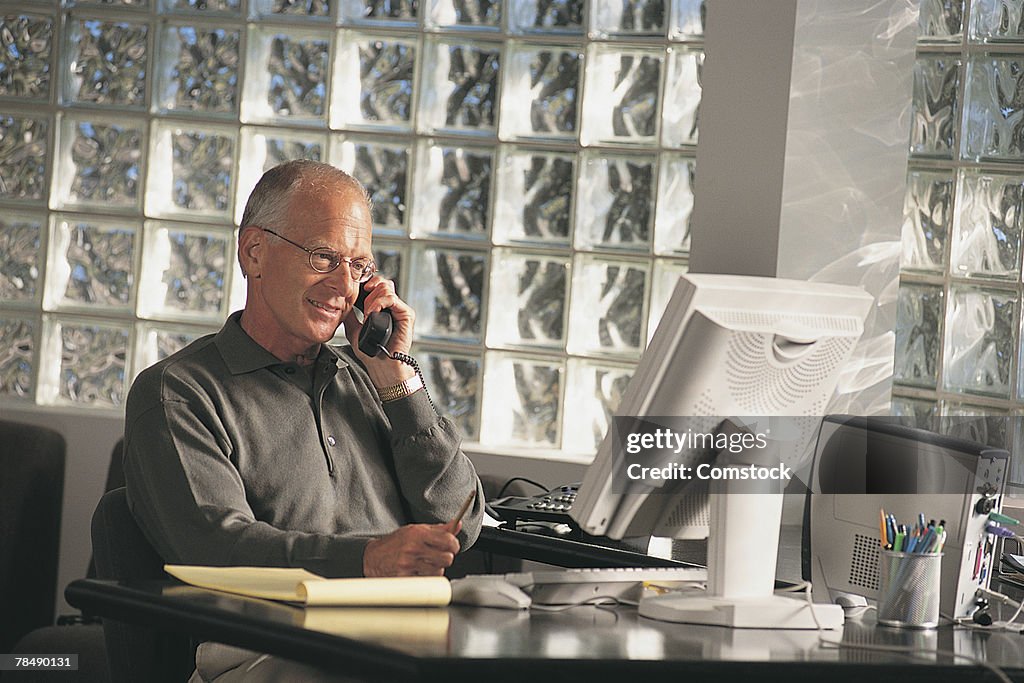 Businessman in office using a telephone