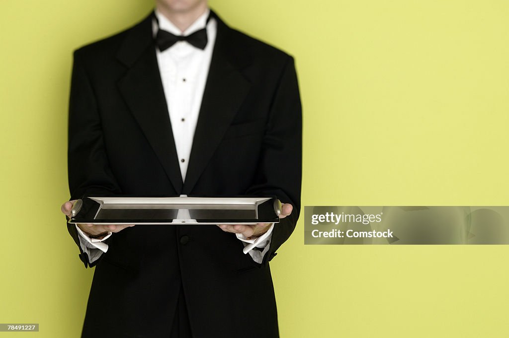 Butler in tuxedo with tray