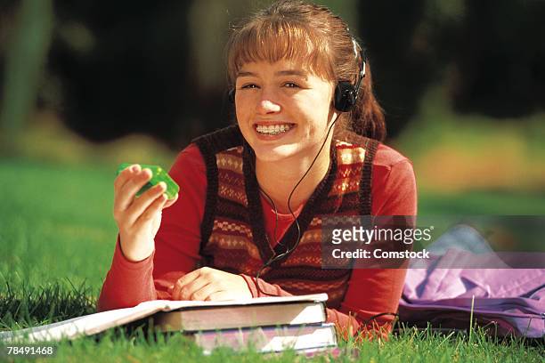 teenage girl student lying down on lawn holding beeper - 1990 1999 fotografías e imágenes de stock