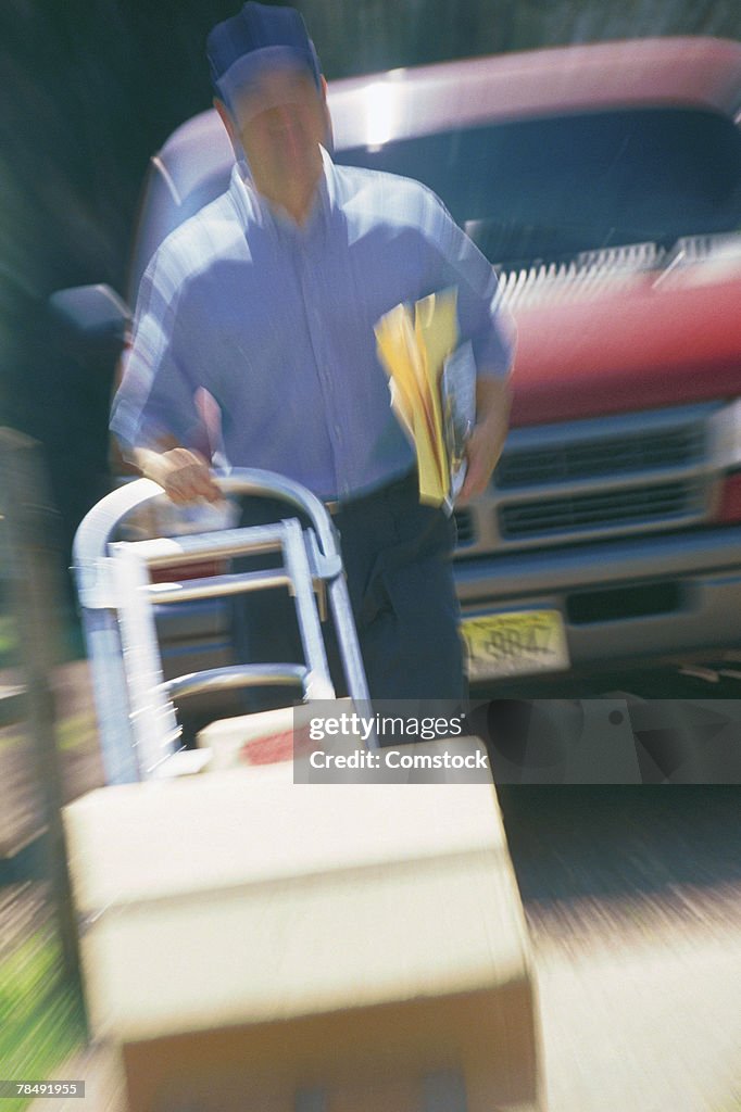 Delivery man pushing boxes