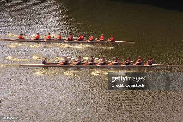 crew teams rowing in river - sculling stock-fotos und bilder