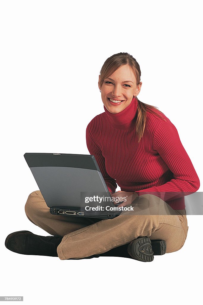 Woman sitting with laptop computer