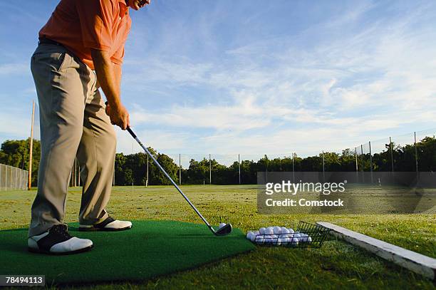 man on driving range - driving range stock pictures, royalty-free photos & images