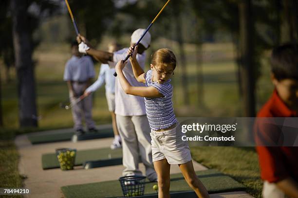 children practicing at a driving range - driving range stock pictures, royalty-free photos & images