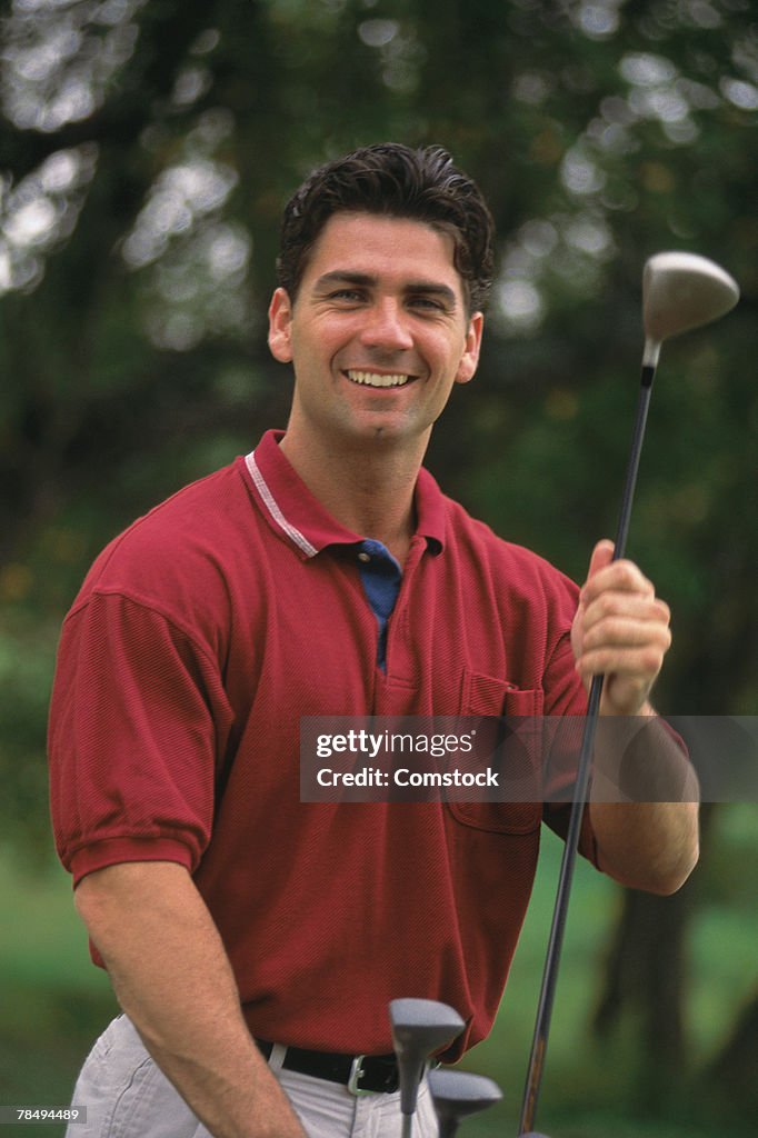 Man posing with golf club