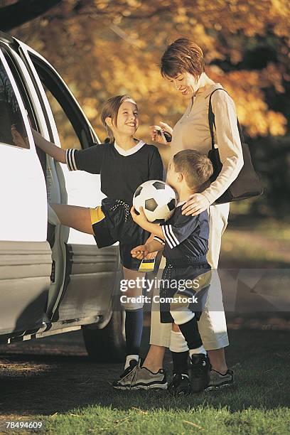 mother and children getting in van after soccer game - soccer mom stock pictures, royalty-free photos & images