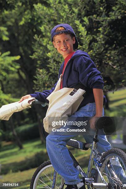 boy on newspaper delivery route - zeitungsausträger stock-fotos und bilder