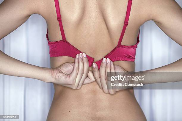 woman's hands fastening bra - bra stock pictures, royalty-free photos & images