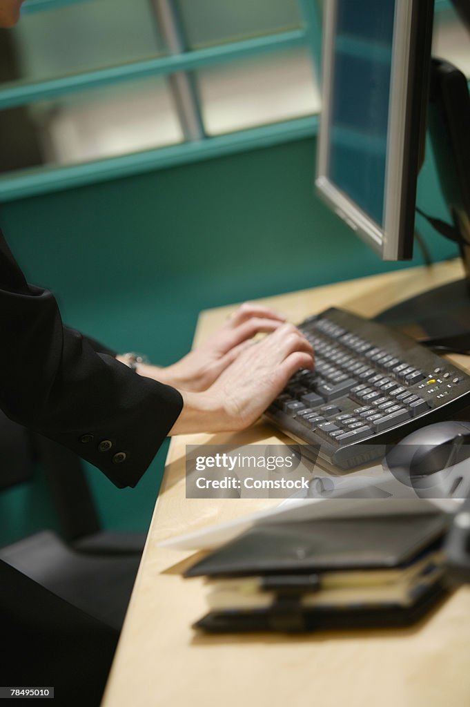 Woman typing on keyboard