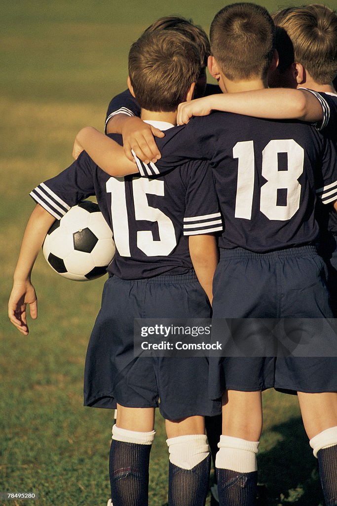 Kids in soccer huddle