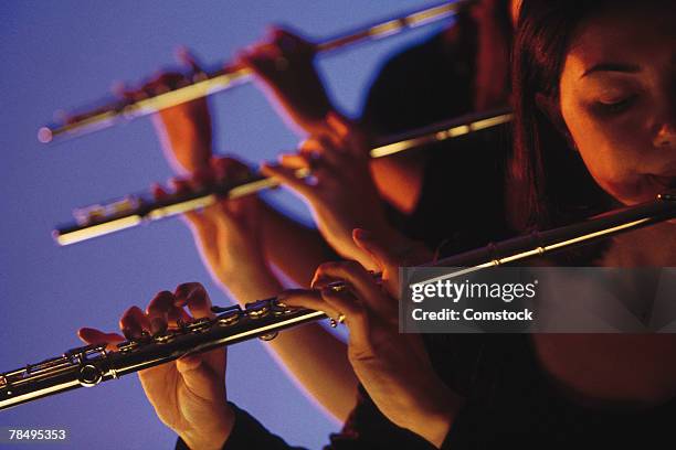 flautists playing - orchestra sinfonica foto e immagini stock