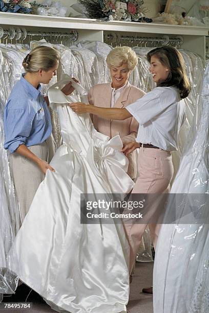 women looking at wedding dresses - wedding planning stock pictures, royalty-free photos & images