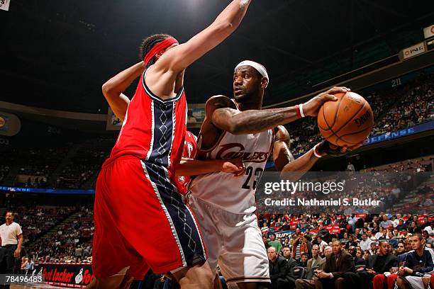 Josh Boone of the New Jersey Nets guards LeBron James of the Cleveland Cavaliers on December 14, 2007 at the IZOD Center in East Rutherford, New...