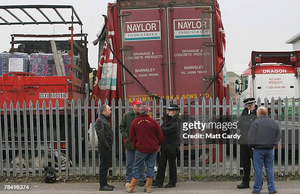 Police chat with the handful of fuel price protesters at the Texaco oil refinery on December 15, 2007 in Cardiff, Wales. Despite the small turnout of...