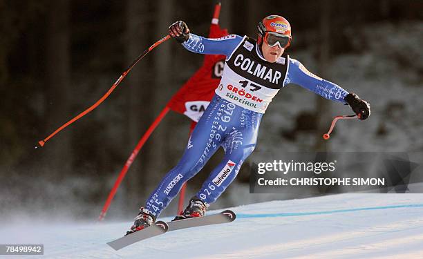 Swiss Didier Cuche clears a gate to clock the second best time during the Men's FIS Alpine World Cup Downhill event in Val Gardena, 15 December 2007....