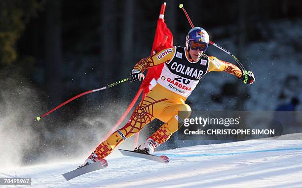Canadian's Erik Guay clears a gate to clock the fourth best time during the Men's FIS Alpine World Cup Downhill event in Val Gardena, 15 December...