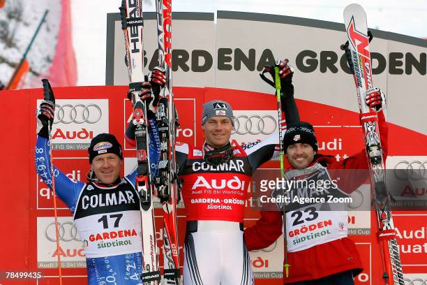 Didier Cuche of Switzerland celebrates second place, Michael Walchhofer of Austria celebrates first place and Scott Macartney of the USA celebrates...