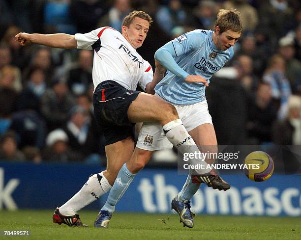 Michael Johnson of Manchester City vies with Kevin Davies of Bolton during the Premier league football match at The City of Manchester Stadium,...