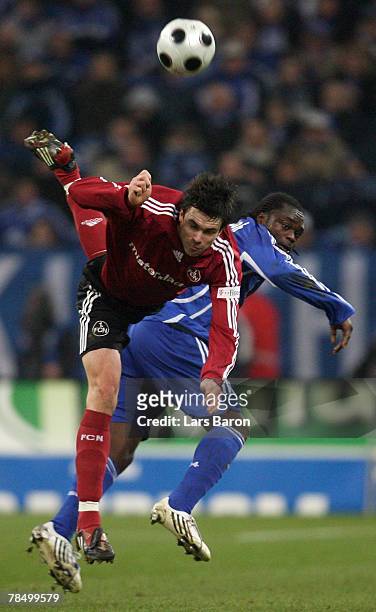 Michael Beauchamp of Nuernberg in action with Gerald Asamoah of Schalke during the Bundesliga match between Schalke 04 and 1. FC Nuernberg at the...