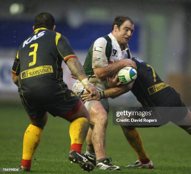 Clarke Dermody of London Irish is tackled by Dominic Chouly during the Heineken Cup match between Perpignan and London Irish at Stade Aime Giral on...