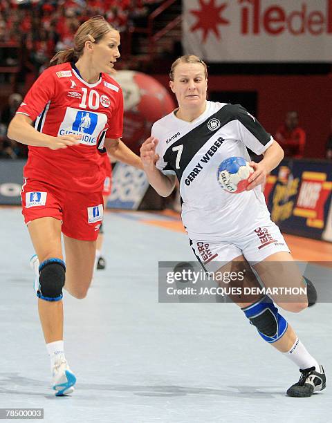 Germany's Nina Worz tries to break away from Norway's Gro Hammerseng during the women world championship handball semi final match Norway vs....