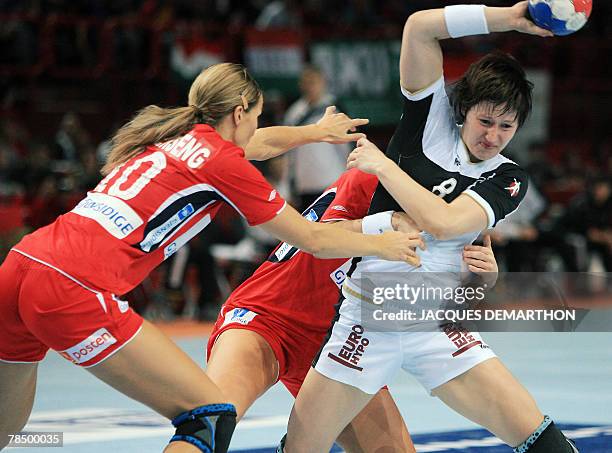 Norway's Gro Hammerseng tries to stop Germany's Anne Muller during the women world championship handball semi final match Norway vs. Germany, 15...