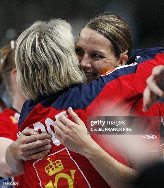 Norway's Gro Hammerseng is congratulated by her coach Marit Breivik after winning the women world championship handball semi final match Norway vs....