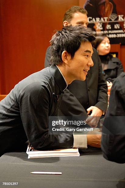 Musical pop star and Omega Ambassador Richie Jen does a signing with customers following his press conference at Carat & Karat store on December 15,...