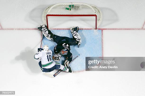 Mathieu Garon of the Edmonton Oilers makes a sprawling save on Trevor Linden of the Vancouver Canucks at Rexall Place December 15, 2007 in Edmonton,...