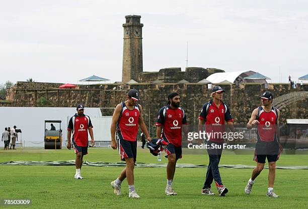England players from left to right, Ravi Bopara, Alastair Cook, Monty Panesar, Stuart Broad and James Anderson walk across a wet outfield back to the...