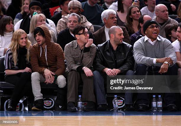 Singer Ashlee Simpson, musician Pete Wentz of Fall Out Boy, Alan Cumming with guest and LL Cool J attend NJ Nets vs NY Knicks game at Madison Square...