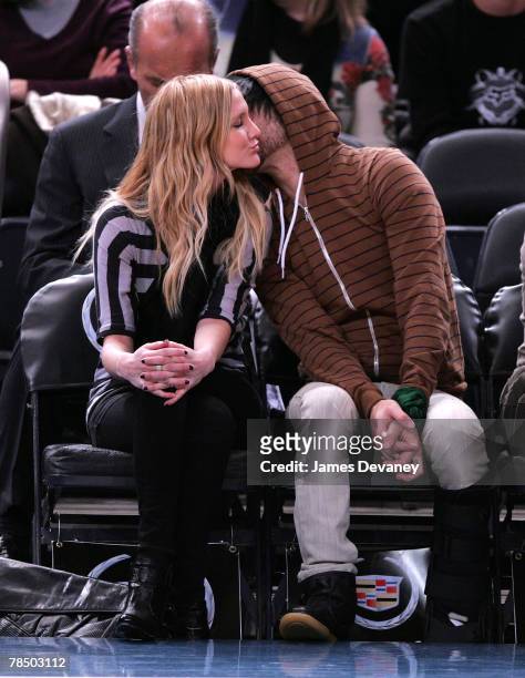 Singer Ashlee Simpson and musician Pete Wentz of Fall Out Boy attend NJ Nets vs NY Knicks game at Madison Square Garden in New York City on December...