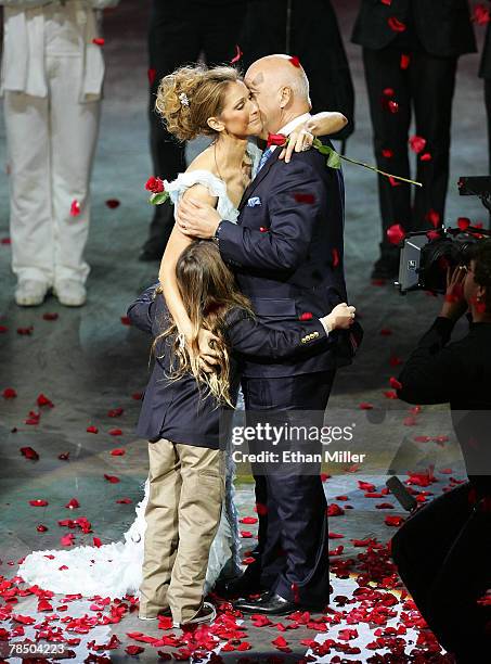 Singer Celine Dion is embraced by her husband and manager Rene Angelil and their son Rene-Charles Angelil after the final performance of her show "A...