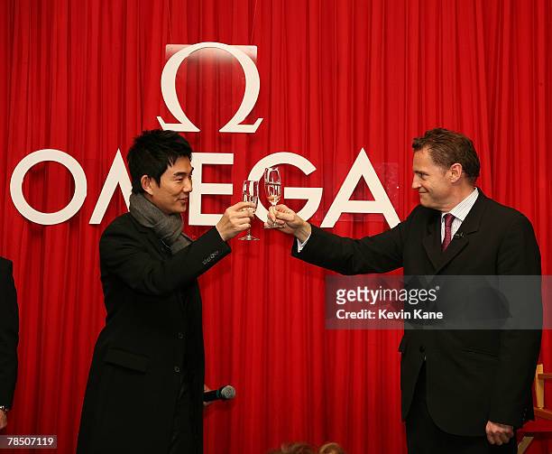 Musical pop star and Omega Ambassador Richie Jen toasts with Omega Brand President USA, Gregory Swift after attending the Carat & Karat store on...