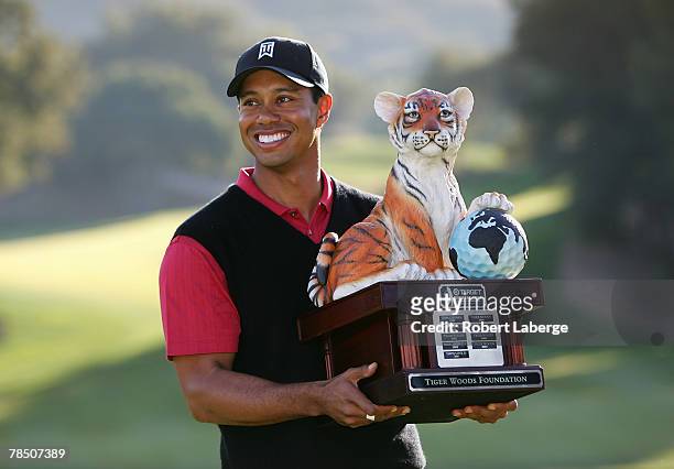 Tiger Woods poses with the winner's trophy after winning the Target World Challenge at the Sherwood Country Club on December 16, 2007 in Thousand...