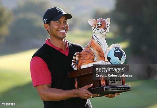 Tiger Woods poses with the winner's trophy after winning the Target World Challenge at the Sherwood Country Club on December 16, 2007 in Thousand...