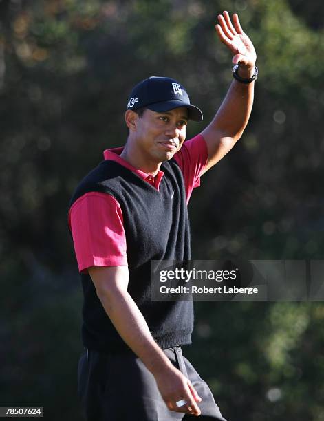 Tiger Woods waves to the crowd on his way to picking up the winner's trophy after winning the Target World Challenge at the Sherwood Country Club on...