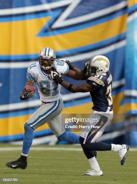 Calvin Johnson of the Detroit Lions stiff arms Antonio Cromartie of the San Diego Chargers during the third quarter at Qualcomm Stadium December 16,...