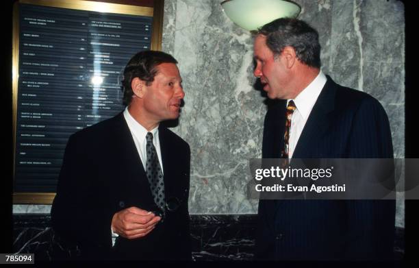 Disney chairman Michael Eisner and president Michael Ovitz shake hands at a press conference August 19, 1996 in New York City. Eisner and Ovitz...