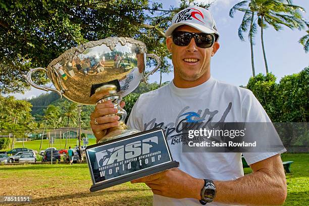 Foster's ASP Men?s World Champion Mick Fanning of Australia poses with his World Title trophy at the Banzai Pipeline, at an impromptu press...