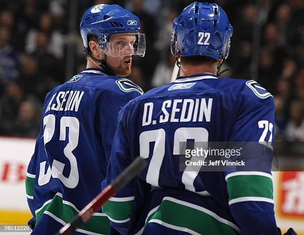 Daniel Sedin and Henrik Sedin of the Vancouver Canucks talk strategy during their game against the the Pittsburgh Penguins at General Motors Place on...