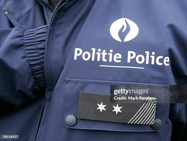 The logo on a police uniform is written in both French and Flemish on December 17, 2007 in Brussels, Belgium. French speaking Walloons are resisting...